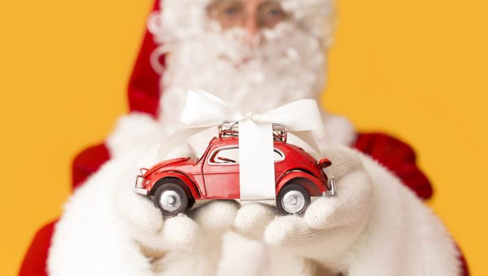 blurred-santa-claus-suggesting-toy-car-with-M8L6PR6